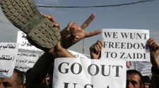 Iraqis take to the streets over arrest of journalist who threw shoes at US President Bush